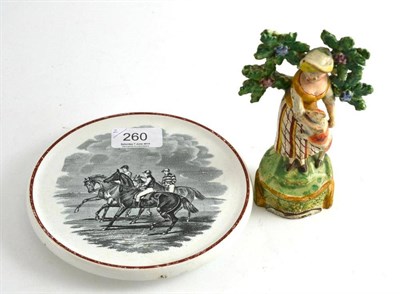 Lot 260 - Copeland circular teapot stand printed with racehorses and a pearlware figure (2)