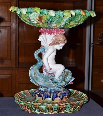 Lot 272 - A Majolica centrepiece modelled as Cupid riding a dolphin beneath a fern basket, possibly...