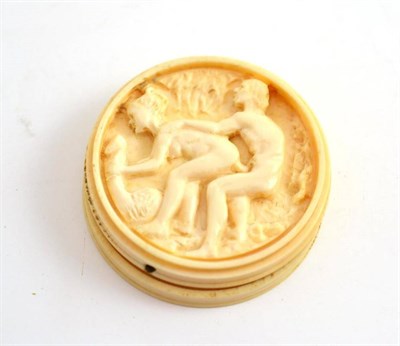 Lot 288 - A carved ivory brothel token, circular, the lift off lid revealing a man and woman fornicating,...