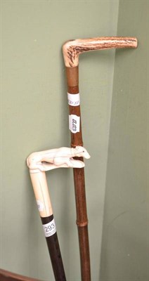 Lot 293 - Walking cane mounted with a carved dog and another with horn handle (2)