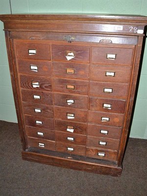 Lot 379 - Oak filing cabinet of twenty-four drawers and tambour front