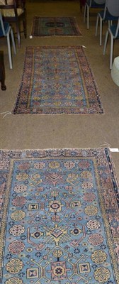 Lot 446 - A pair of light blue ground rugs within a peach border and a similarly coloured patterned rug (3)