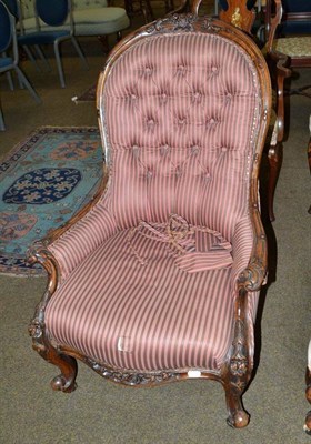 Lot 455 - A Victorian walnut button back armchair in striped upholstery