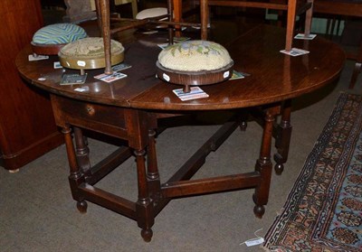 Lot 485 - An oak double gateleg dining table