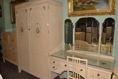 Lot 504 - Early 20th century cream and floral painted double door wardrobe with hanging space, stamped...
