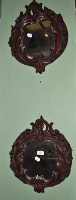 Lot 523 - A pair of carved mahogany wall mirrors