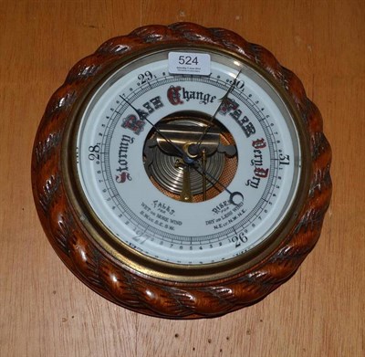 Lot 524 - An aneroid barometer in an oak frame