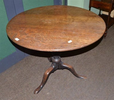Lot 527 - A George III oak tripod table