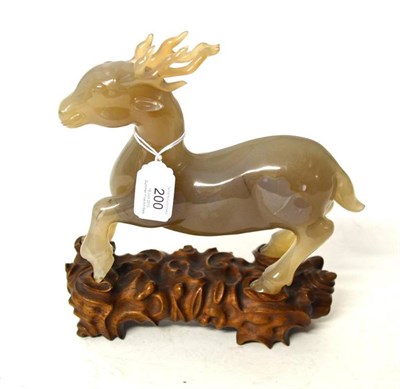 Lot 200 - A Chinese Carved Chalcedony Figure of a Deer, Qing Dynasty, in prancing pose, 17.6cm high,...