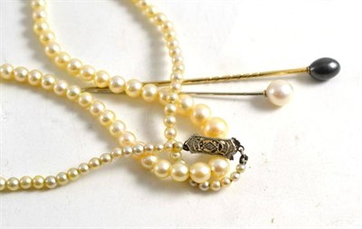Lot 12 - A strand of cultured pearls with diamond set clasp and two stick pins