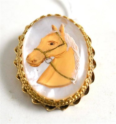 Lot 17 - A mother-of-pearl backed horse brooch in a 9ct gold pendant/brooch frame