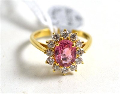 Lot 26 - An 18ct gold pink sapphire and diamond cluster ring