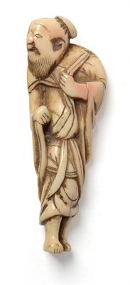 Lot 210 - A Japanese Carved Ivory Netsuke as a Bearded Sage, 18th/19th century, standing and turning to...