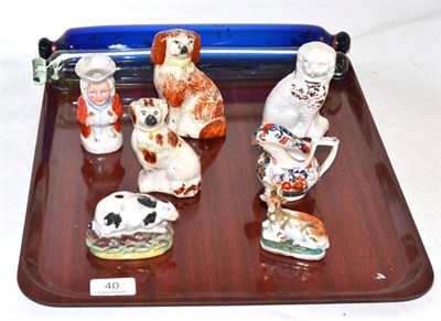 Lot 40 - A collection of Staffordshire including a small rabbit on a grassy base, a Bristol Blue rolling pin