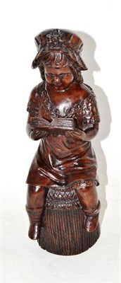 Lot 47 - A carved wooden model of a girl reading a book, bears signature ";R Mercier"
