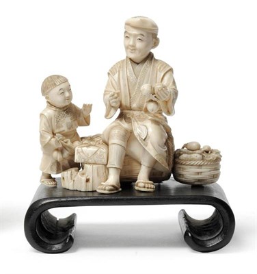 Lot 214 - A Japanese Carved Elephant Ivory Group of a Farmer and Boy, late Meiji period (1868-1912), the...