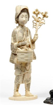 Lot 215 - A Japanese Carved Walrus and Elephant Tusk Composite Figure of a Countrywoman, circa 1910, standing