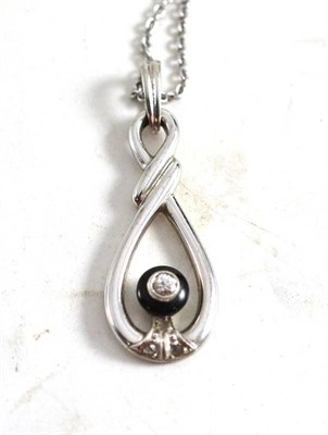 Lot 132 - A diamond and onyx pendant on a fine chain