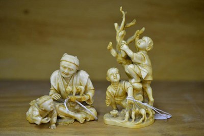 Lot 220 - A Japanese Ivory Okimono, early 20th century, as a father and son seated on a rush mat playing with