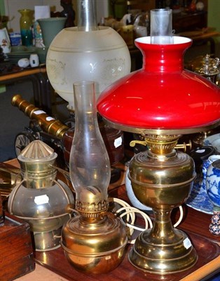 Lot 153 - An oil lamp with ruby glass reservoir, a gimbal mounted oil lamp and another (3)