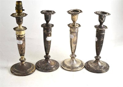 Lot 166 - Set of four American filled sterling candlesticks by Kirk & Sons, complete with nozzles