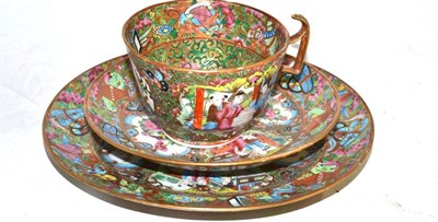 Lot 231 - A Chinese famille rose tea cup, saucer and plate, painted all-over (including bases) with figures