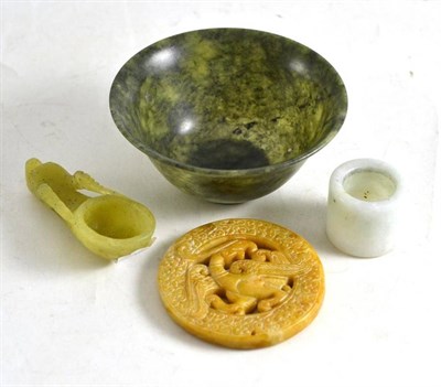 Lot 283 - A jade-type bowl, pierced disk, archers thumb ring and dragon bowl (4)