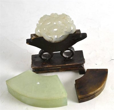 Lot 286 - A jade-type pierced stone roundel on stand, two crescent shape boxes and covers