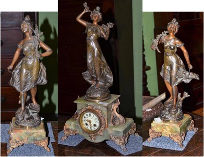 Lot 292 - An onyx and spelter striking mantel clock with garniture