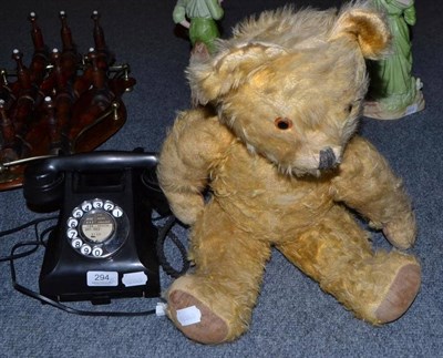 Lot 294 - Black Bakelite telephone converted for modern use and a jointed Pedigree teddy bear with growler