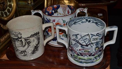 Lot 298 - A 'Tykes Motto' earthenware mug, a 'God Speed the Plough' twin handled mug and an ironstone mug (3)