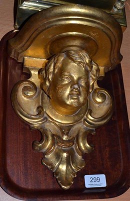 Lot 299 - A late 19th century carved giltwood wall bracket modelled with a child's head