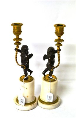 Lot 242 - A Pair of Early 19th Century Parcel Gilt Bronze and Carrara Marble Figural Table Candlesticks, each