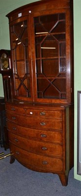 Lot 372 - A reproduction walnut secretaire bookcase in late Georgian style