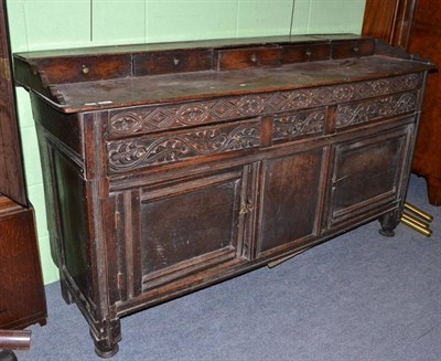 Lot 374 - 17th/18th century carved oak sideboard