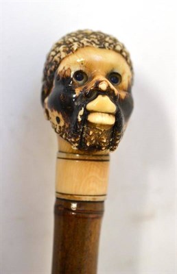 Lot 252 - A Carved and Stained Ivory Articulated Walking Cane, late 19th century, as a black man's head, well