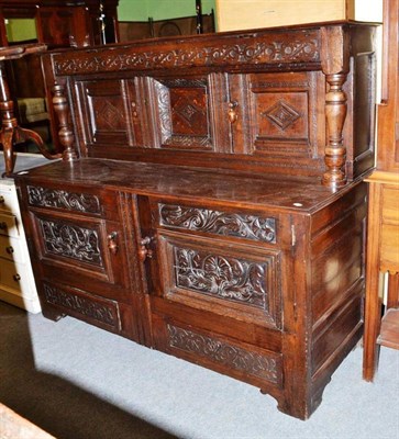 Lot 459 - Court cupboard with carved panels and acorn knop handles