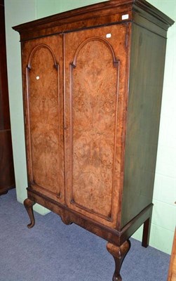 Lot 475 - A reproduction walnut wardrobe with burr walnut panelled doors