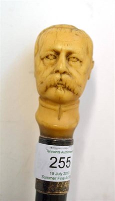 Lot 255 - A Carved Ivory Walking Cane as Lord Kitchener, circa 1900, with silver ferrule and ebonised...