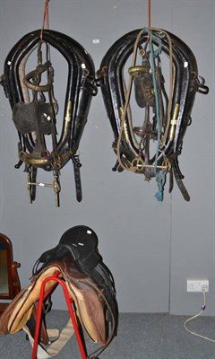 Lot 521 - A collection of leather and brass horse tack including saddle, blinkers, headgear, head collars etc