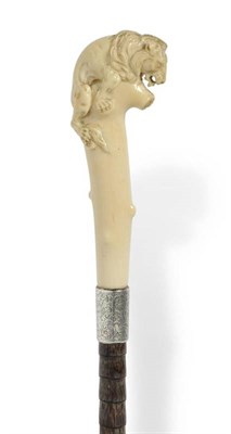 Lot 257 - An Ivory Handled Walking Stick, circa 1904, the grip carved as a lion surmounting a tree trunk with