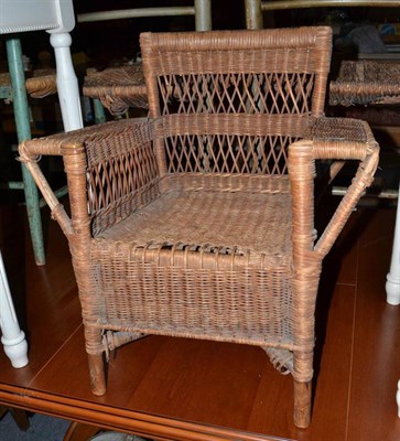 Lot 553 - An Arts & Crafts Dryad wicker child's chair - metal plaque to base