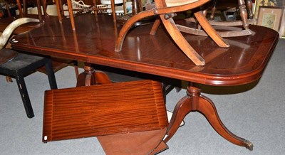 Lot 556 - A reproduction mahogany twin pedestal dining table