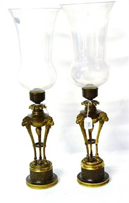 Lot 262 - A Pair of Regency Parcel Gilt Bronze Hurricane Lanterns, with acanthus leaf socles supporting...