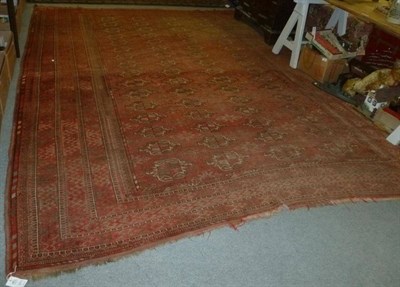 Lot 583 - A large red ground rug and another