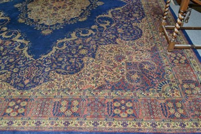 Lot 584 - Machine made carpet of unusual size , the indigo field with central medallion framed by floral vine