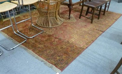 Lot 585 - A red and rust ground rug