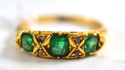 Lot 12 - An 18ct gold emerald and diamond ring (a.f. - emeralds chipped)