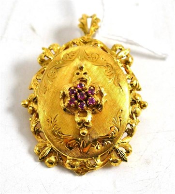 Lot 16 - An 18ct gold ruby set brooch/locket
