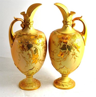 Lot 47 - Pair of Royal Worcester blush ivory pedestal ewers with gilt decoration